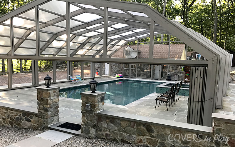 Alternate angled exterior view of closed residential pool enclosure with opened bifold doors in Kinnelon