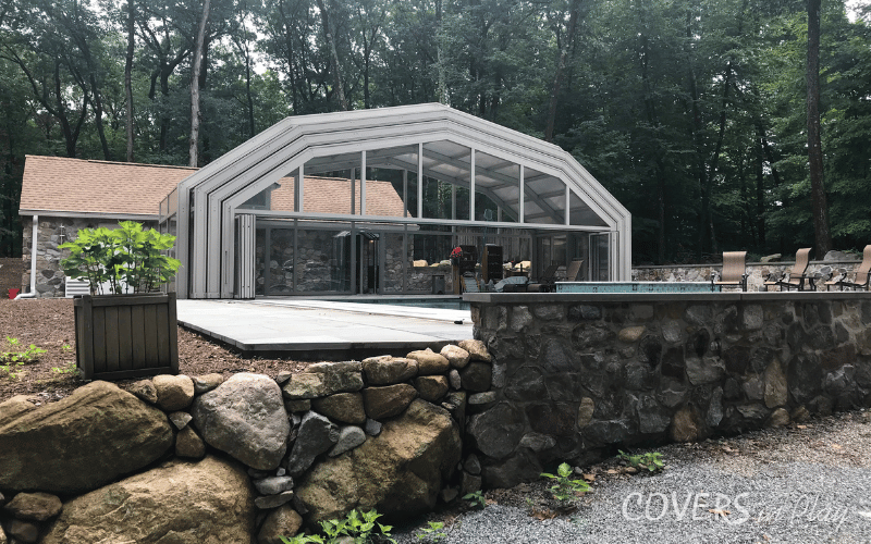 Front view of Kinnelon pool dome from a stone pathway of residential home