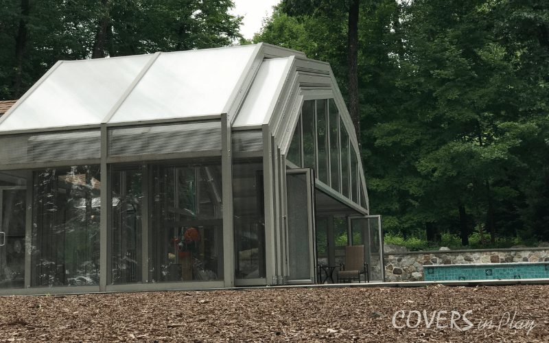 Rear view of opened residential pool dome in Kinnelon backyard