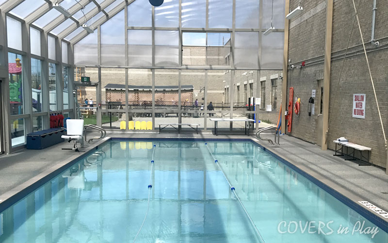 Interior of commercial pool enclosure in Mississauga, showing various pool equipment on the pool deck.