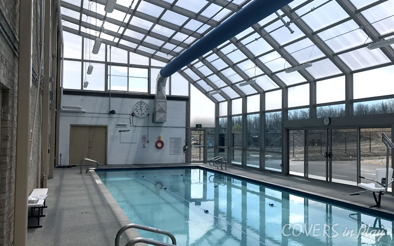 Interior of commercial pool enclosure in Mississauga, showing the attached pool house.