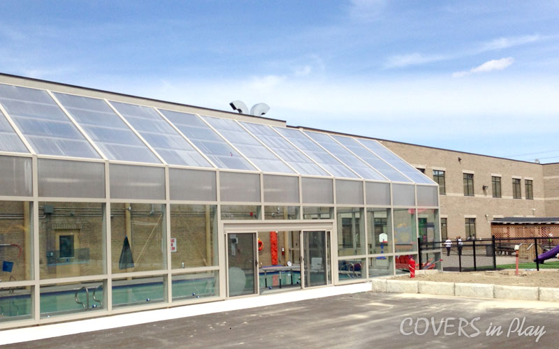 Exterior side view of commercial pool enclosure in Mississauga, showing the wide sliding doors for easy access.