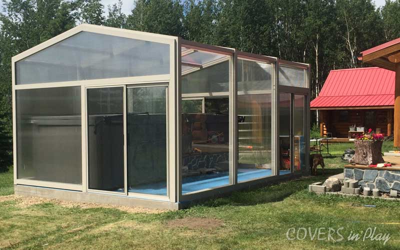 Exterior side angle of hot tub enclosure, showing the clear acrylic walls for natural light.