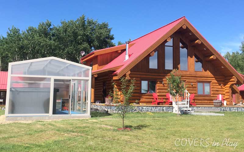 Wide view of hot tub enclosure beside log home in Barrhead, AB