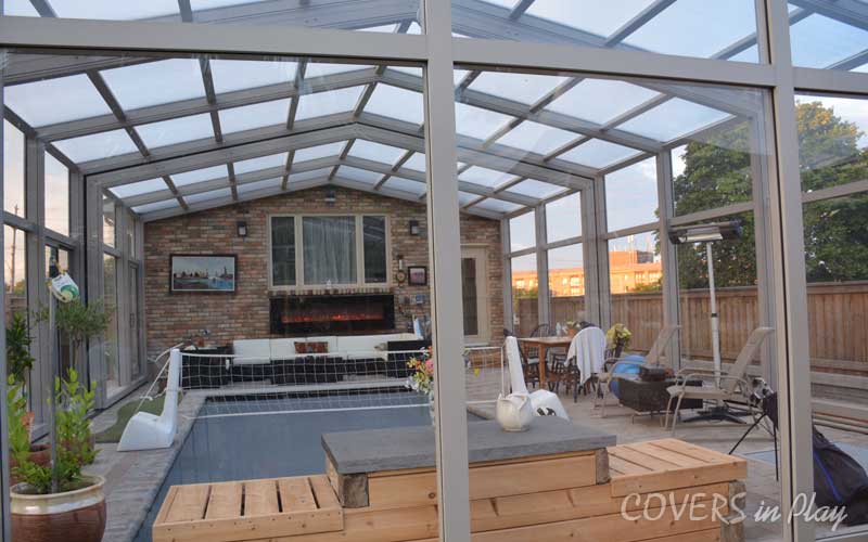 Outside rear view of a closed pool enclosure attached to residential house in Burlington