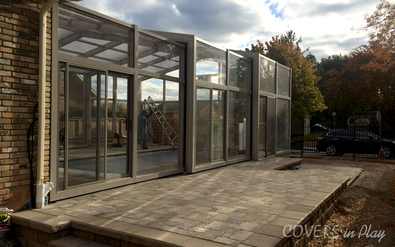 Side outside view of a closed pool enclosure with clear windows in Burlington