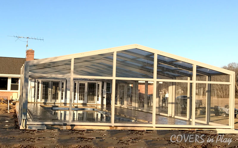 Exterior rear view of a closed pool enclosure with clear windows in Clayton