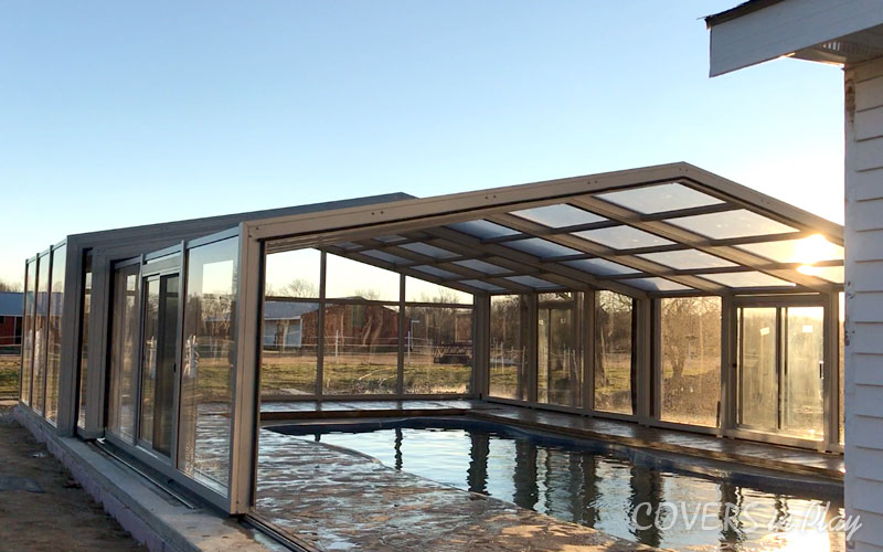 Outside view of an opened pool enclosure with clear windows in Clayton