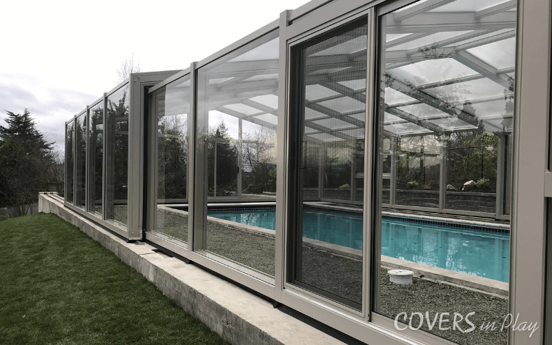 Exterior side view of swimming pool dome surrounded by trees in Edgewood, WA