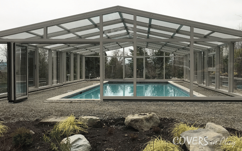 Exterior view of residential pool dome with opened bifold doors in Edgewood, WA
