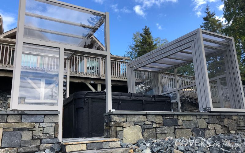Exterior close-up of opened residential retractable hot tub enclosure in Kenora, ON