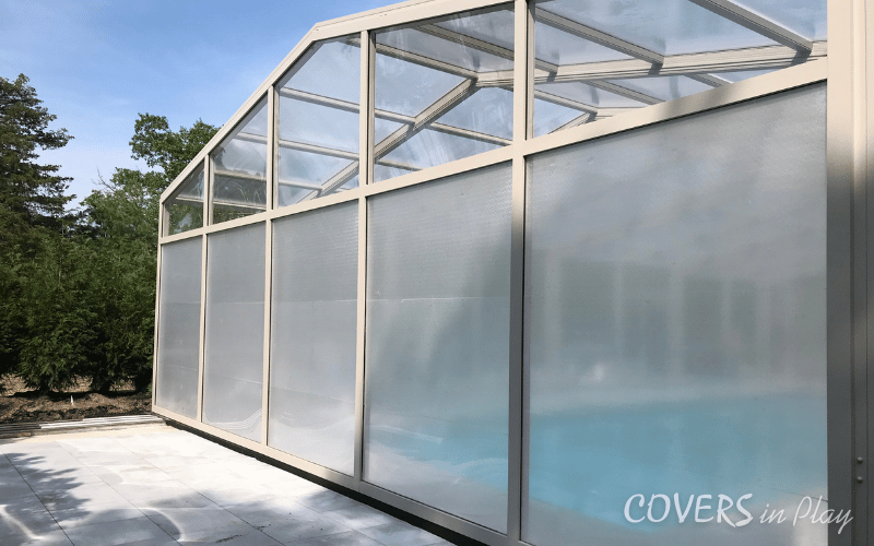 An exterior rear view of a closed retractable pool enclosure in Lakewood