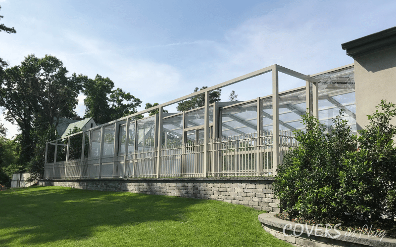 Exterior side view of closed retractable pool enclosure in Lakewood