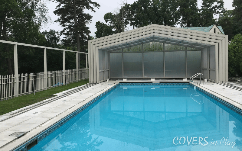 Front interior view of opened residential retractable pool enclosure in Lakewood backyard