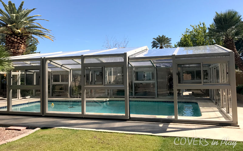 Side exterior view of closed retractable pool enclosure in a residential home in Mesa