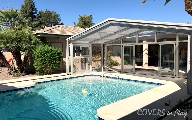 Alternate side angle exterior view of opened residential pool dome cover in Mesa
