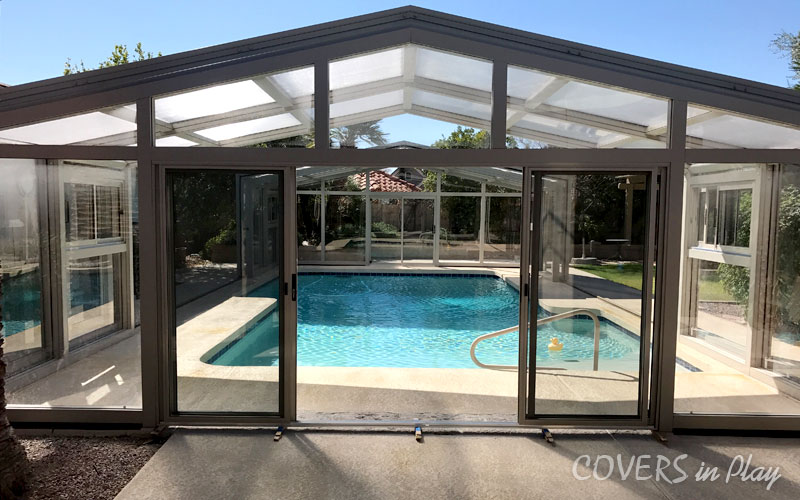 Rear exterior view of opened residential pool dome cover in Mesa with sliding doors