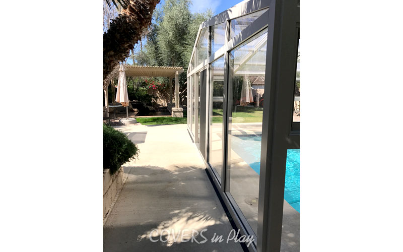 rear side exterior view of retractable pool enclosure in Mesa residential home