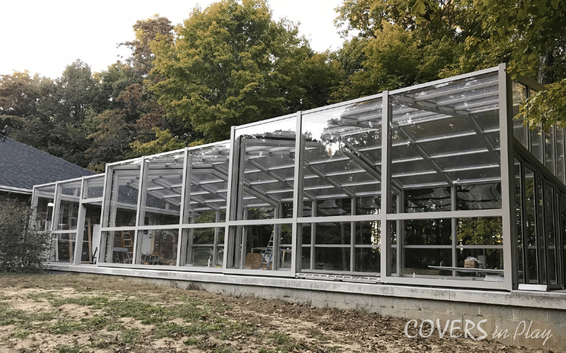 Side-angled exterior view of a retractable pool cover in Paris