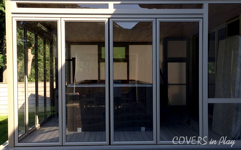 Exterior view of swim spa enclosure with bi-fold doors closed and shielding the interior from the outdoor weather.