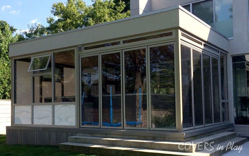 Wide view of swim spa enclosure with bi-fold doors closed and window open, allowing air to flow through.