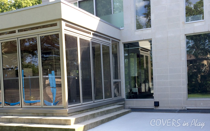 Exterior of swim spa enclosure with bifold doors closed, the structure seamlessly attached to the house.