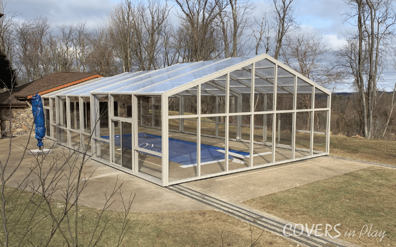 Side view of large backyard pool enclosure in Triadelphia, WV