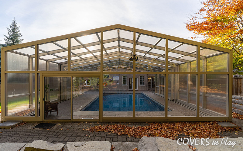 Rear view of closed pool enclosure attached to a house in Whitby in the fall
