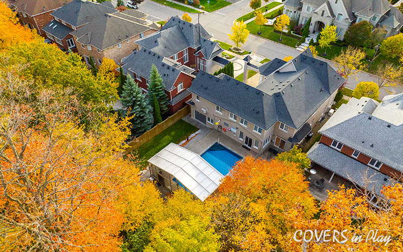 Top view of opened pool enclosure and house in suburban neighbourhood in Whitby