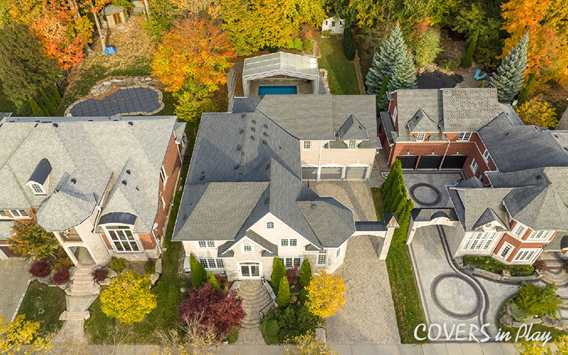Top view of opened pool enclosure and house in suburban neighbourhood in Whitby