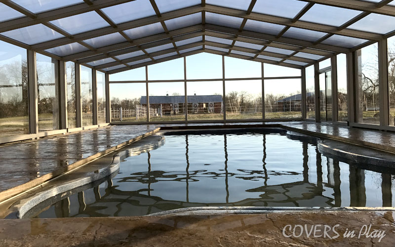 Front view of a closed pool enclosure with clear windows in Clayton