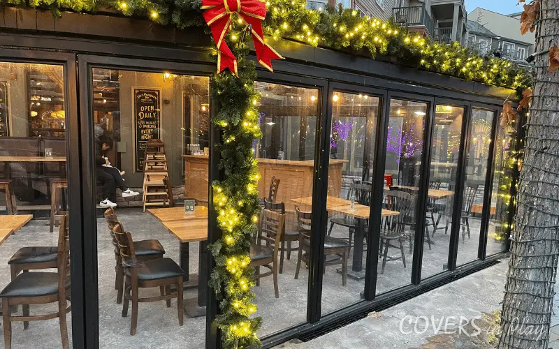 Close-up of bi-fold doors on commercial Blue Mountain patio enclosure with Christmas lights