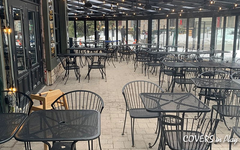 Indoor view of patio enclosure at Blue Mountain restaurant, closed bi-fold doors, with snow on the ground outside