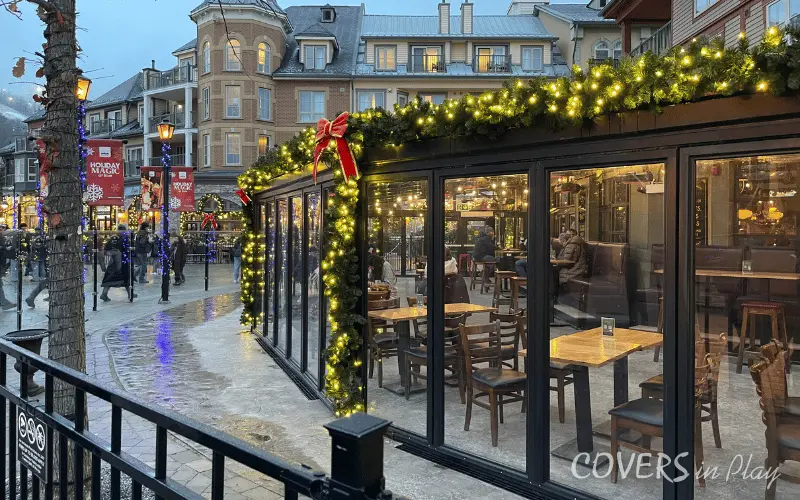 Alternate angle of commercial Blue Mountain patio enclosure with bi-fold doors and Christmas lights