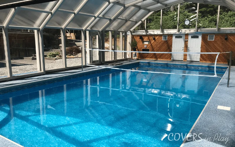 Interior view of closed pool enclosure with installed volleyball net in Mission