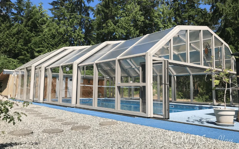 Exterior view of pool enclosure with open bi-fold doors in BC