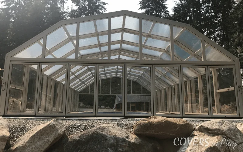 Center rear view of a retractable enclosure in BC, with closed bi-fold doors