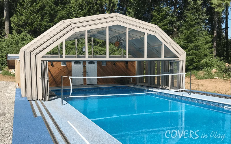 Exterior view of open pool enclosure surrounded by forest in Mission, BC
