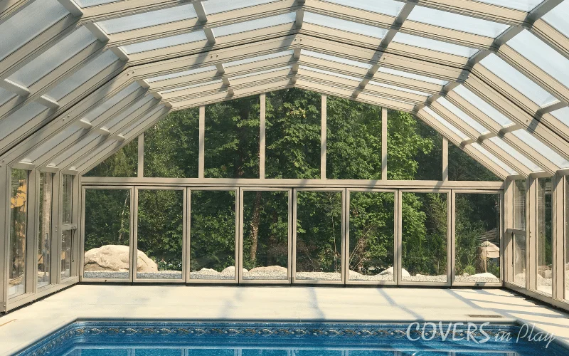Interior rear view of closed pool enclosure in BC, with closed bi-fold doors at the end bay