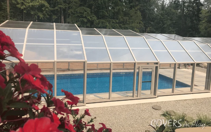 Exterior side view of pool enclosure and flowers in BC