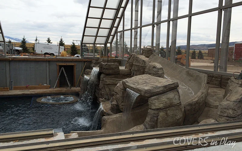 Exterior angled view of opened swimming pool dome and waterfall in Nephi, UT