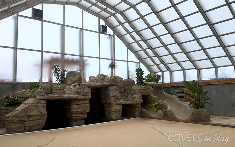 Interior angled view of residential pool dome and waterfall structure in Nephi, UT